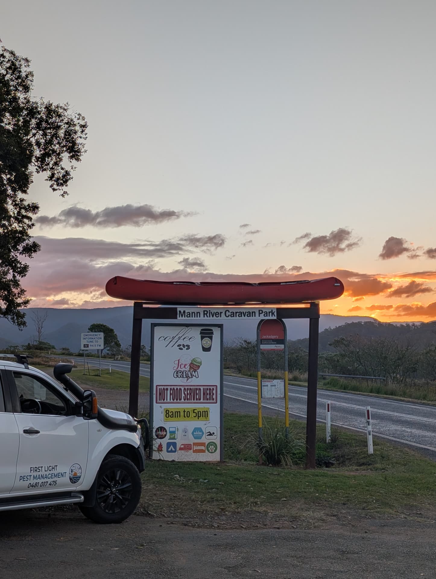 The First Light ute parked at the Mann River Caravan Park at Jackadgery as the sun sets behind the ranges
