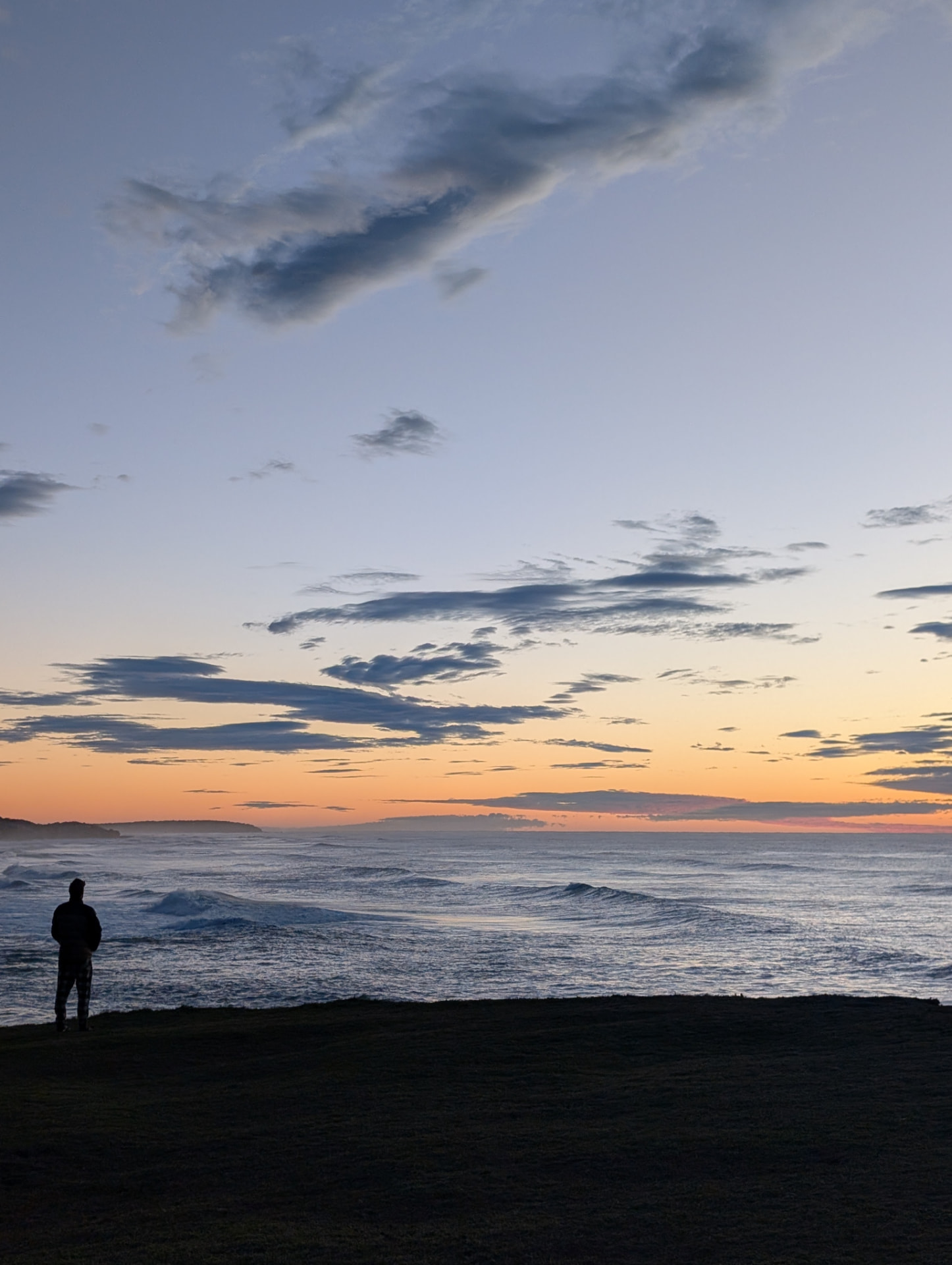 Sunrise over the ocean on the Northern Rivers coast with a lone figure watching the surf